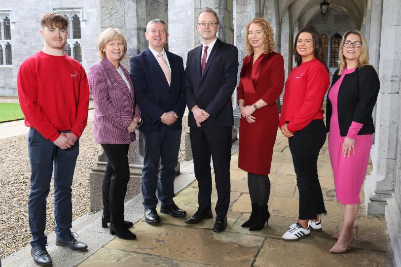 University staff, alumni and PwC Representatives against Quad background