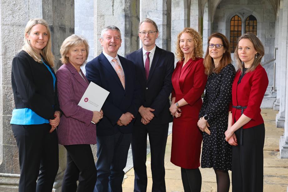 University staff and PwC Representatives against Quad background